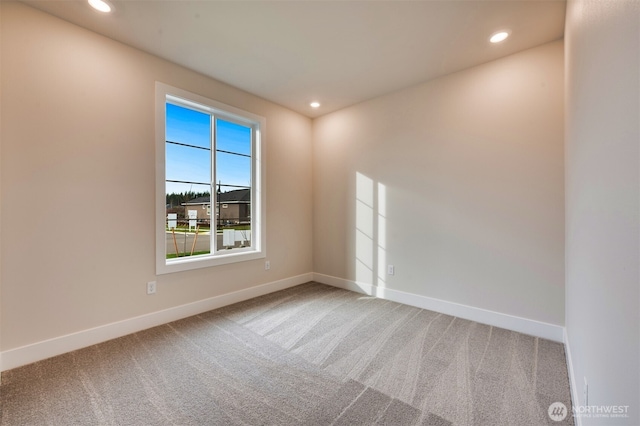 carpeted spare room with recessed lighting and baseboards