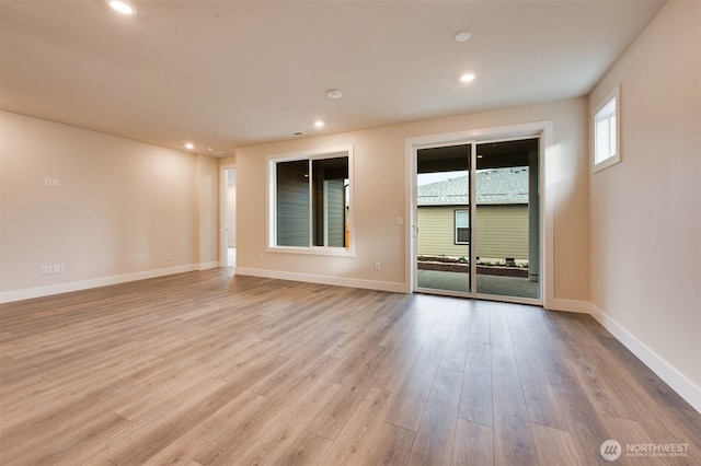 empty room featuring recessed lighting, baseboards, and wood finished floors