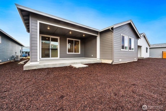 rear view of property with a patio and central AC unit
