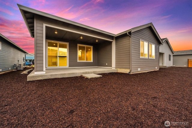 rear view of property with a patio and central AC