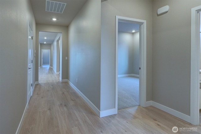 hall featuring visible vents, recessed lighting, light wood-style flooring, and baseboards