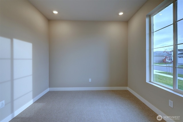 spare room featuring baseboards, carpet flooring, and recessed lighting