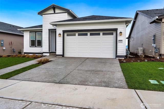 view of front of property with a garage, driveway, and a front lawn