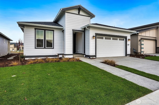 view of front of home with an attached garage, driveway, a shingled roof, and a front lawn