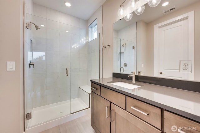 full bathroom featuring vanity, visible vents, and a stall shower