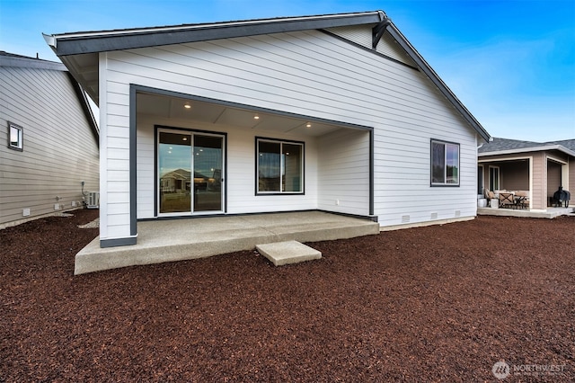 back of property with a patio