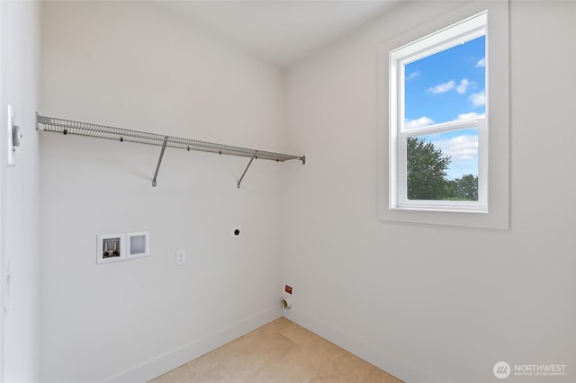 laundry area with hookup for an electric dryer, washer hookup, baseboards, and light tile patterned floors