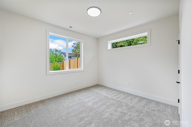 carpeted empty room with baseboards