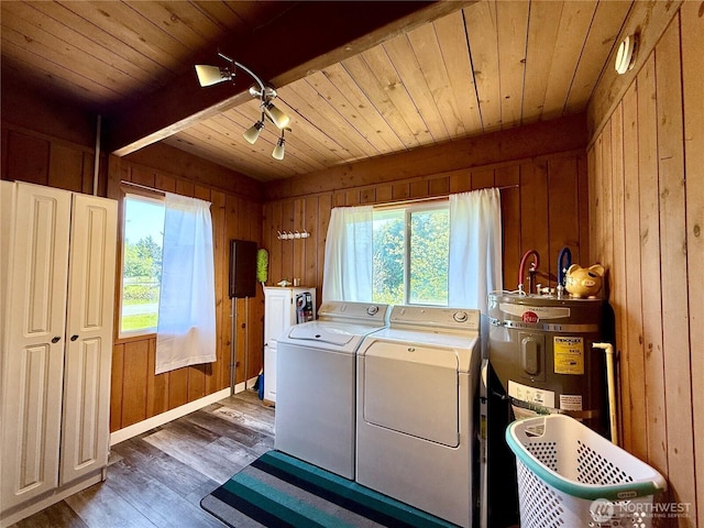 washroom featuring wooden walls, laundry area, and washing machine and clothes dryer