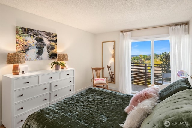 bedroom featuring a textured ceiling, access to exterior, and baseboards
