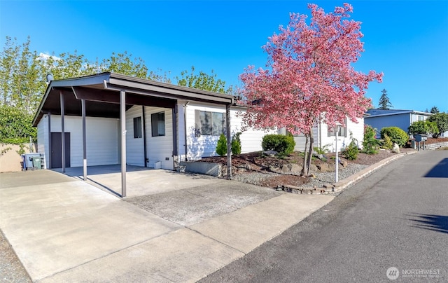 ranch-style house featuring driveway and a carport