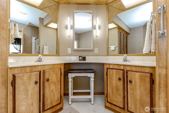 bathroom with double vanity, a sink, and tile patterned flooring