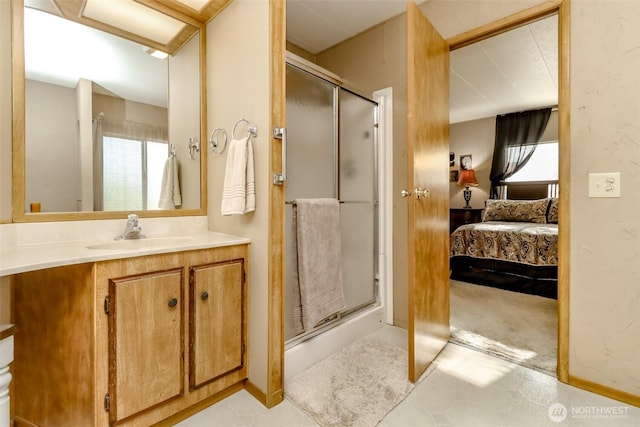 bathroom featuring vanity, tile patterned flooring, connected bathroom, and a stall shower