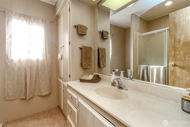 bathroom with vanity, toilet, and a stall shower