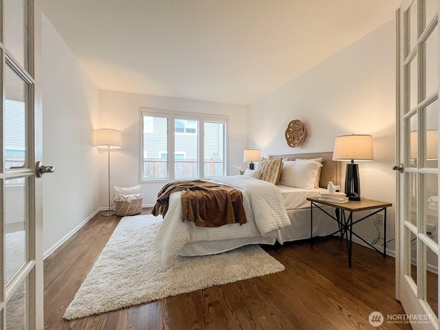 bedroom featuring baseboards, dark wood-style floors, and french doors