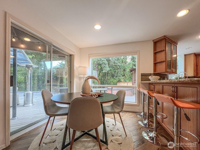 dining space featuring recessed lighting, dark wood finished floors, and a healthy amount of sunlight