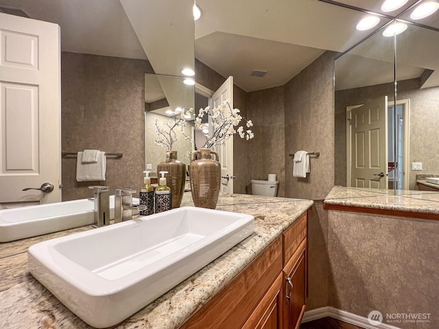 bathroom with vanity and visible vents