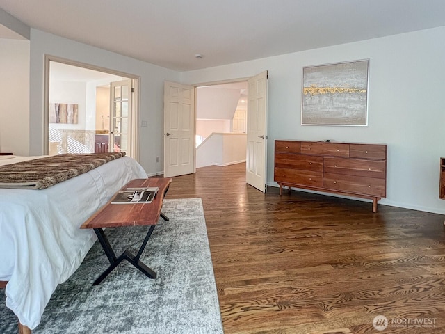 bedroom with baseboards and dark wood-style floors