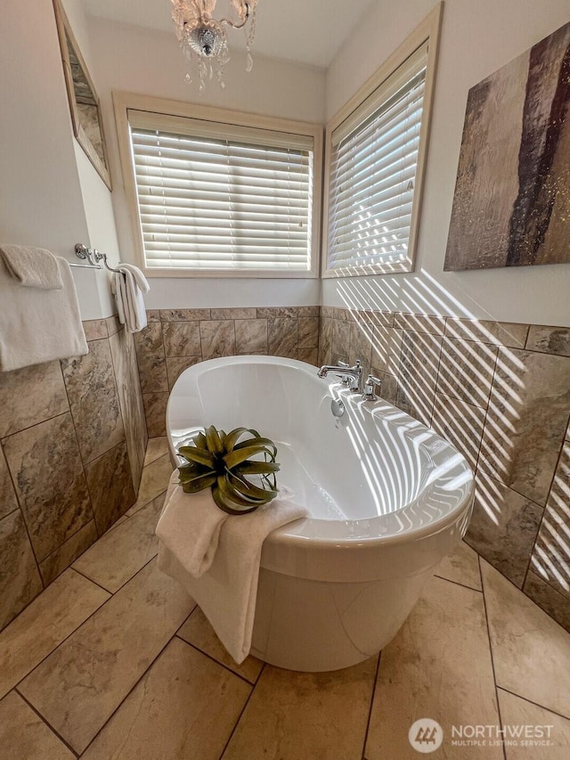 full bath with tile patterned floors and a washtub