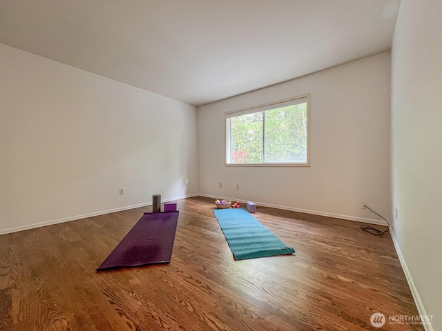 unfurnished room featuring baseboards and wood finished floors