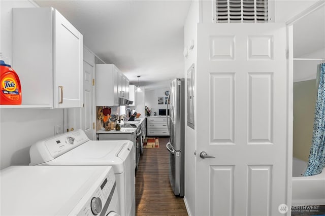 20323 Jordan Rd, Arlington, WA 98223 - washroom featuring separate washer and dryer and dark wood finished floors