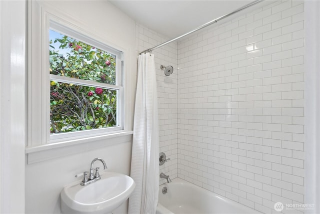 bathroom featuring a sink and shower / bath combo