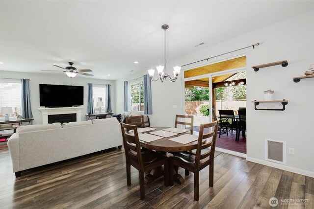 dining area featuring visible vents, dark wood finished floors, baseboards, ceiling fan with notable chandelier, and recessed lighting