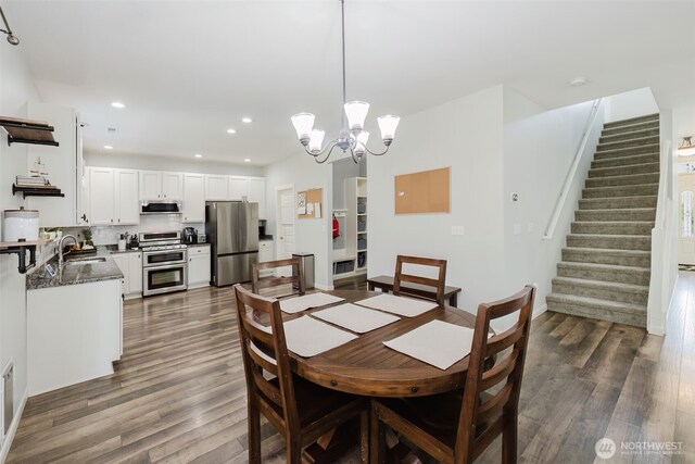 dining area with stairway, recessed lighting, dark wood-style flooring, and a notable chandelier