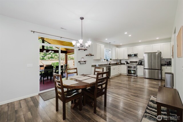 dining area featuring dark wood-type flooring, recessed lighting, a chandelier, and visible vents