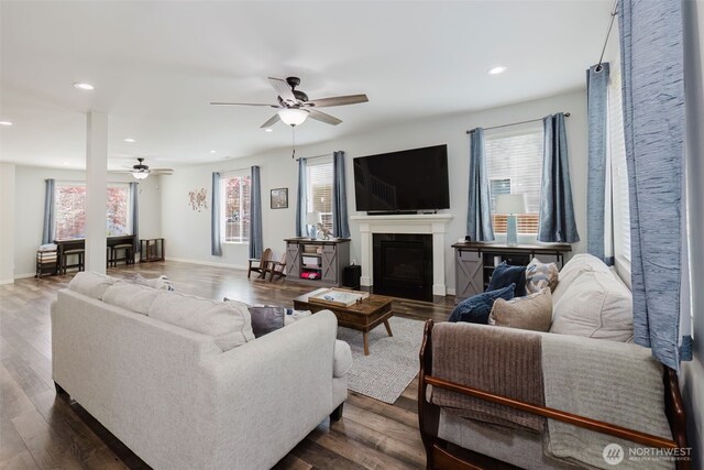 living room featuring a ceiling fan, recessed lighting, and plenty of natural light
