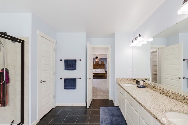 ensuite bathroom with double vanity, a shower stall, a sink, tile patterned floors, and ensuite bathroom