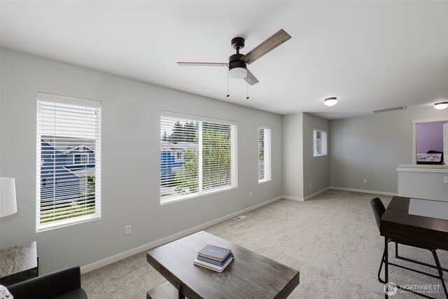 carpeted living area featuring ceiling fan, visible vents, and baseboards