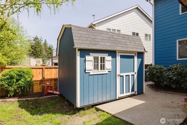 view of shed featuring fence