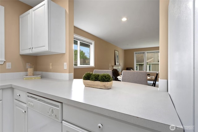 kitchen with dishwasher, light countertops, open floor plan, recessed lighting, and white cabinetry