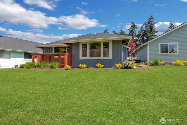 exterior space with board and batten siding and a yard