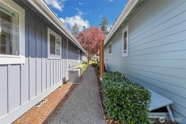view of home's exterior featuring board and batten siding and central AC