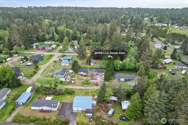 aerial view featuring a residential view and a wooded view
