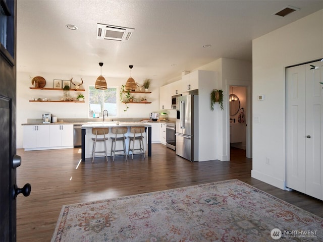 159 Bootjack Ln, Kelso, WA 98626 - kitchen featuring white cabinetry, open shelves, appliances with stainless steel finishes, and a kitchen breakfast bar