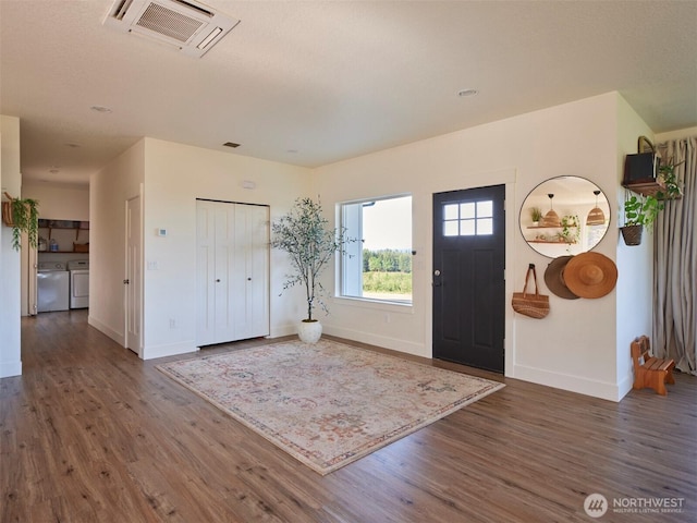 159 Bootjack Ln, Kelso, WA 98626 - entryway featuring baseboards, visible vents, wood finished floors, and washing machine and clothes dryer