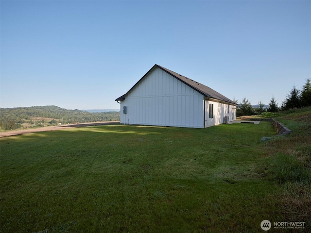 159 Bootjack Ln, Kelso, WA 98626 - view of property exterior with board and batten siding, a mountain view, and a yard