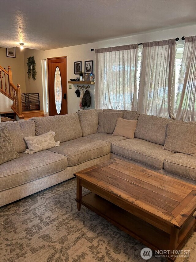 living area featuring stairway