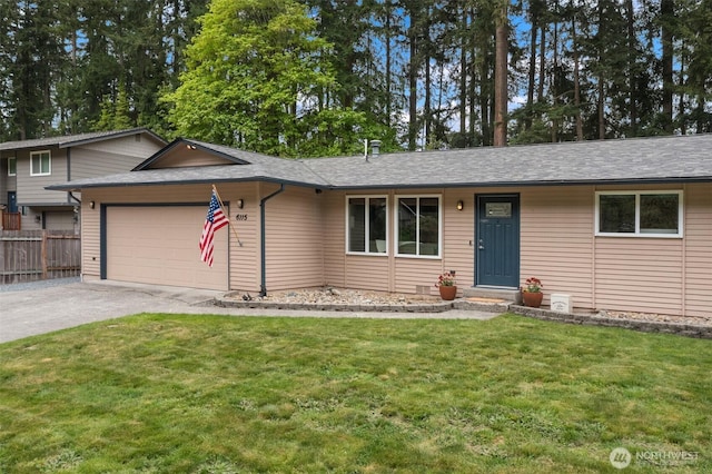 view of front of home featuring an attached garage, fence, driveway, and a front yard