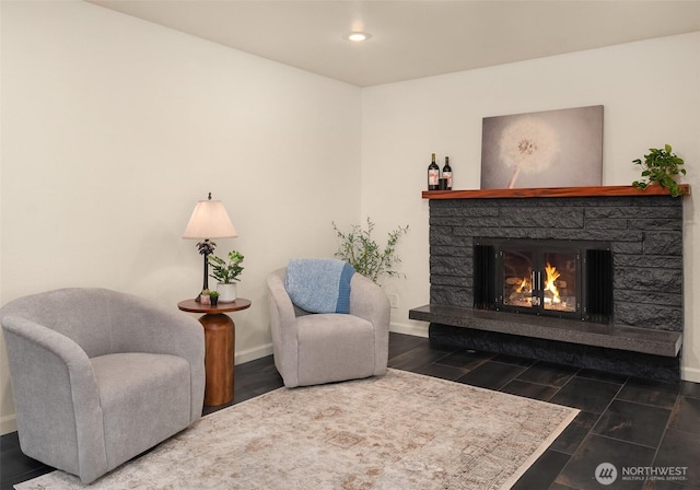 sitting room featuring recessed lighting, baseboards, and a fireplace