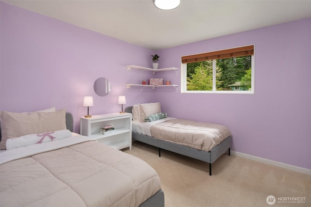 carpeted bedroom featuring baseboards