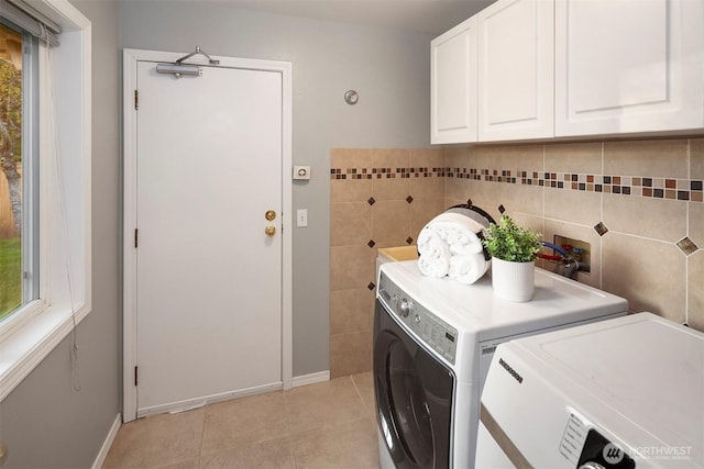 6513 156th Ave SE, Bellevue, WA 98006 - washroom with washer and clothes dryer, cabinet space, light tile patterned floors, and a healthy amount of sunlight
