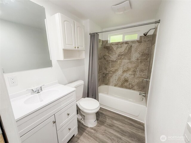 full bathroom featuring vanity, toilet, wood finished floors, and shower / bath combination with curtain
