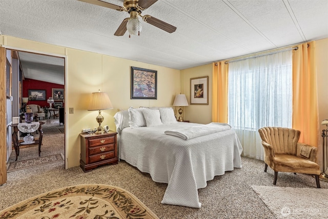 carpeted bedroom with a ceiling fan, a textured ceiling, and lofted ceiling