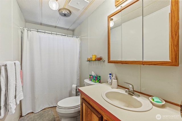 full bath featuring toilet, vanity, and curtained shower