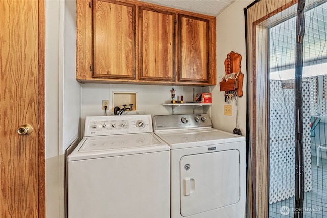 laundry area featuring washing machine and clothes dryer and cabinet space
