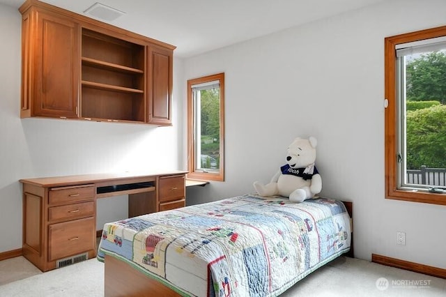 bedroom featuring light colored carpet, baseboards, visible vents, and multiple windows